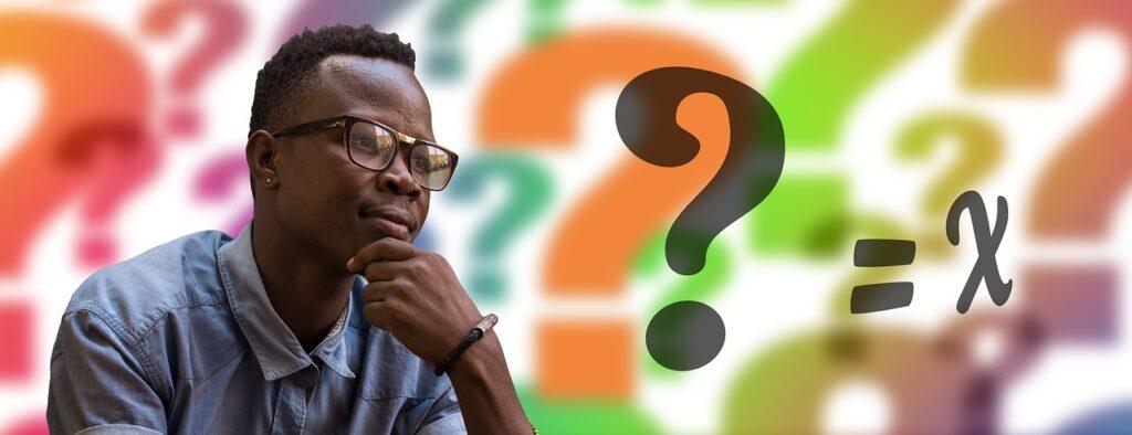 FAQs. A person, rubbing their chin as they ponder a question. There is a large question mark in front of them, and other faded images of question marks, in different colours, in the background.